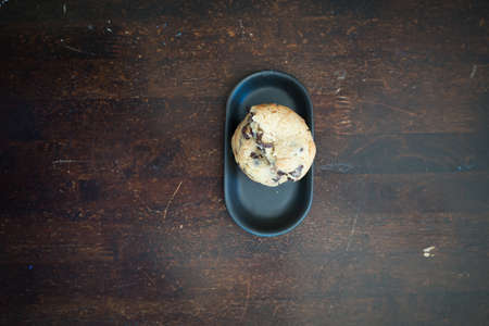 Soft and chewy chocolate chip cookies on a wooden tableの写真素材