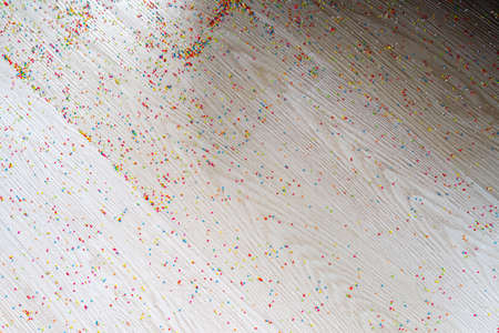 Colourful Sugar sprinkles, decoration on the wooden floor. Messy and scattered. Childhood concept.の写真素材