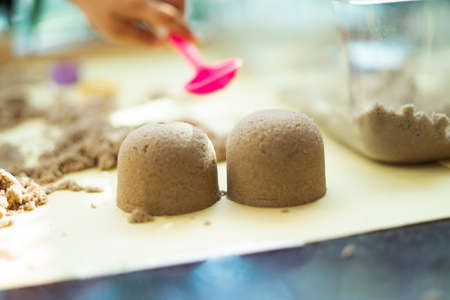 Blurry photo of kinetic sand in preschool. The development of fine motor concept. Creativity Game concept.の写真素材