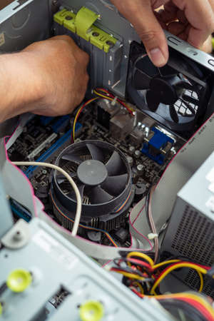 Kuala Lumpur, Malaysia - May 22, 2020:  Cleaning and fixing the personal computer (PC) with a vacuum cleaner. Computer service and maintainance.のeditorial素材