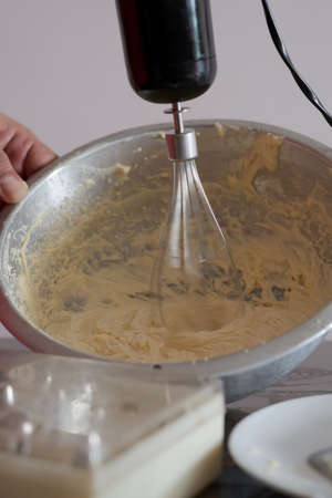 Beating cream. Making butter cream filling. Making torte cupcakes with buttercream filling. Motion...