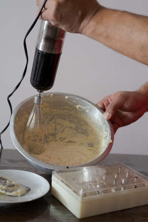 Beating cream. Making butter cream filling. Making torte cupcakes with buttercream filling. Motion...