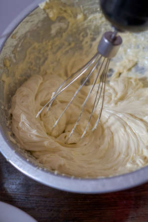 Beating cream. Making butter cream filling. Making torte cupcakes with buttercream filling. Motion...