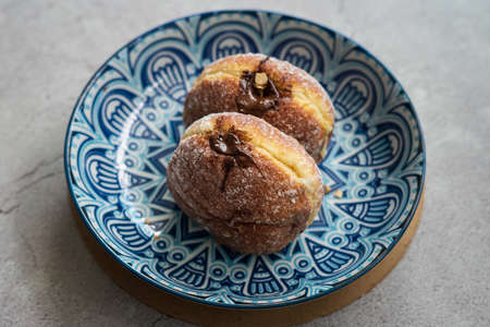 Bomboloni, a donut filled with melted chocolate and eaten as a snack. Bomboloni originated from...
