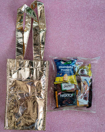 Kuala Lumpur, Malaysia - Jun 27, 2020: Goodies doorgift packaged and paired with gold metallic tote...