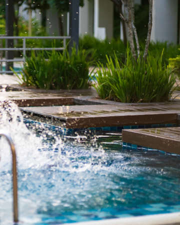 Wooden jumping deck  of swimming pool scene during golden hours with water splash.の写真素材