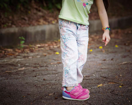 Portrait of a toddler walking outdoor. Enjoying nature.の写真素材