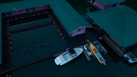 Kenyir, Malaysia - July 22, 2020: Aerial top view of water chalet resort during sunrise in Kenyir...