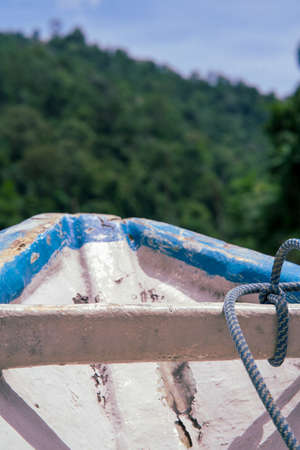 Front of the old boat with green forest island background in a sunny day.の写真素材
