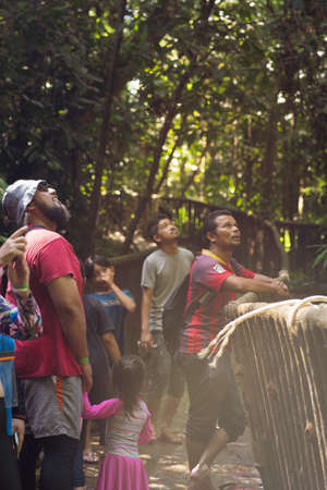 Kenyir, Malaysia - July 23, 2020: Tourist in the forest on the way visiting Kelah Sanctuary.