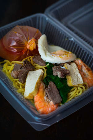 Mee Bandung Muar in a take out box, a Malaysia delicacy noodle originated from Muar District, Johore, Malaysia. The Noodle is a mixed of prawn, meat and seafood. Home delivery service.の写真素材