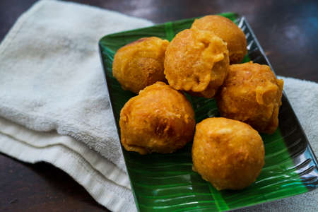 Fried getuk ubi is Malaysian snack food made from tapioca. Fried and served on a banana leaf.