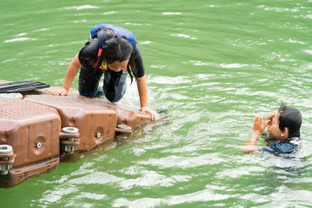Children swimming at the lake.の写真素材