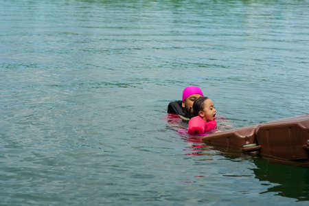 Asian family swimming at the Kenyir Lake, Malaysia.の写真素材