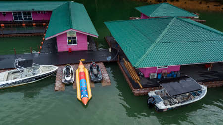 Kenyir, Malaysia - July 23, 2020: Aerial top view of water chalet resort in Kenyir Lake, Terengganu,...