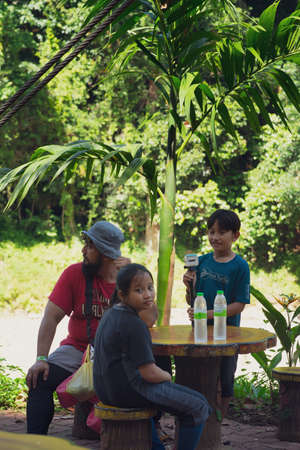 Kenyir, Malaysia - July 23, 2020: Tourist resting at the picnic table on the way visiting Kelah Sanctuary.のeditorial素材