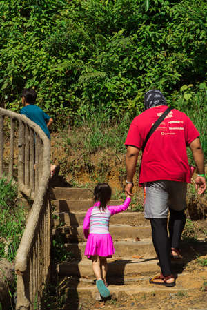 Kenyir, Malaysia - July 23, 2020: Tourist in the forest on the way visiting Kelah Sanctuary.のeditorial素材