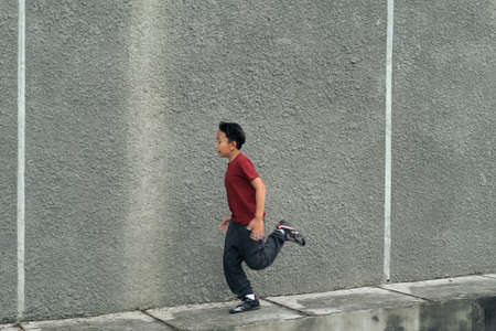 Young asian boy running and work out in outdoor. Active kids. Self care and health care concept.