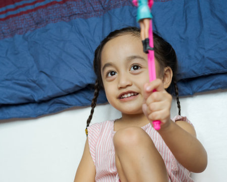 A portrait of young child with braided hair at home. Joy, fun, jovial and happy.の写真素材
