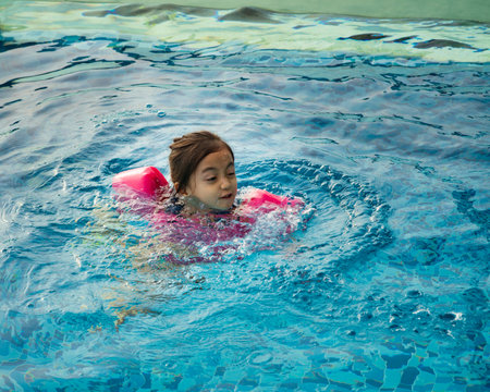 Young little child in the pool. Kid having fun in swimming pool.の写真素材