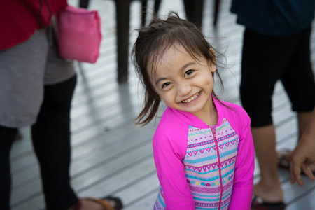 Happy toddler on a boat with family. Vacation, travel and active kid concept.