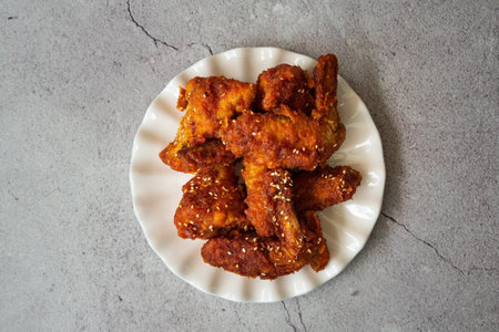 Deep fried chicken wing with hot and spicy sauce in Korean style or asian food concept.の写真素材