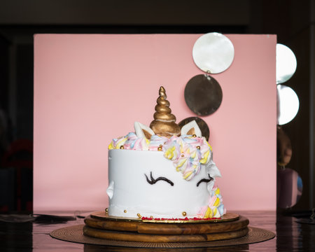 A beautiful bright colourful and white cake decorated in the form of fantasy unicorn. The concept of a festive dessert for kids birthdayの写真素材