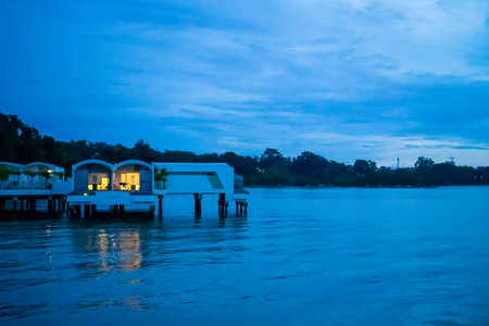 Port Dickson, Malaysia - December 19, 2020: Water chalets at Lexis Hibiscus Hotel and resort during sunset. The image contain soft focus, noise and grain.のeditorial素材