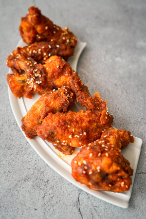 Deep fried chicken wing with hot and spicy sauce in Korean style or asian food concept.の写真素材
