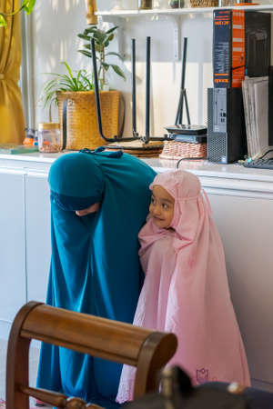 Kuala Lumpur, Malaysia - Dec 6, 2020: Muslim kids, siblings praying together at home.のeditorial素材
