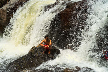 Kenyir, Malaysia - July 23, 2020: Tourist enjoy the beautiful of Lasir waterfall, Kenyir Lake, Terengganu. Lasir waterfall also known as Air Terjun Lasir.のeditorial素材