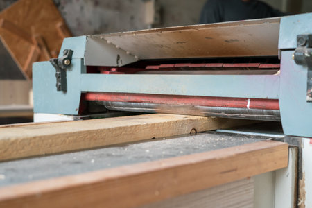 Automated sanding machine for wood boards. Wood plank on the machine.の写真素材