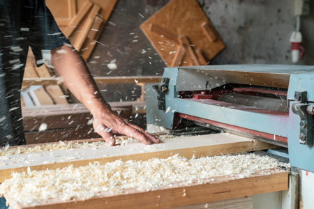 Automated sanding machine for wood boards. Wood dusts scattered everwhere.