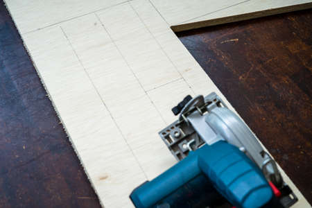 Wood working. Fine quality hardwood lumber, ready for use. electric circular saw on lumber.