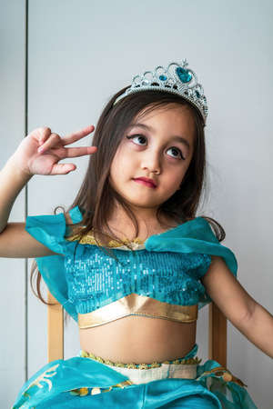 Portrait of a little girl dressed in arabian princess costume against white background. Natural light, selective focus.の写真素材