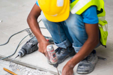 Heavy duty drill next to the construction worker in construction site
