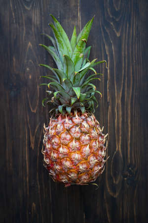 single whole pineapple on a wooden background.の写真素材
