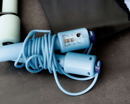 pair of blue skipping rope with pedometer on dark background.の写真素材