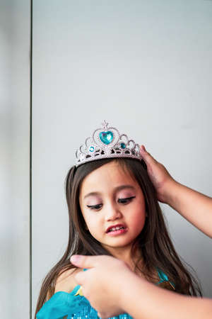 Portrait of a child girl dressed in arabian princess costume against white background. Natural light, selective focus.の写真素材