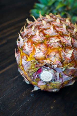single whole pineapple on a wooden background.の写真素材