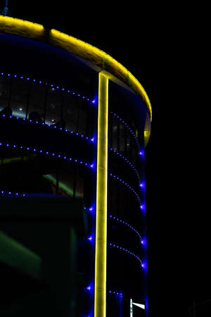 Port Dickson, Malaysia - December 17, 2020: LED light illuminated colored on tall building at night. The photo might contain noise.のeditorial素材