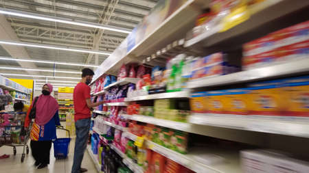 Bangi, Malaysia - March 28, 2021: People shopping at the supermarket. wearing face masks.