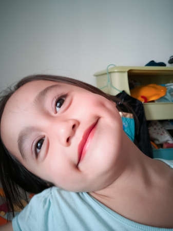 Portrait of a happy cute child Asian girl.の写真素材