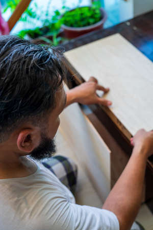 Asian man woodworking DIY at home in the balcony. Home improvement project. Top view.の写真素材