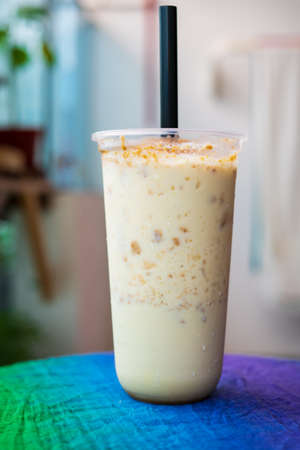 Iced blended caramel coffee topped with crushed caramel biscoff in plastic glass. Hot season refreshing drinks.の写真素材