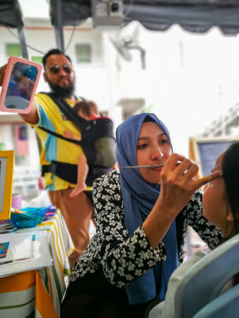 Bangi, Malaysia - May, 2018 : Children face painting. Artist painting little girl at the shop.のeditorial素材