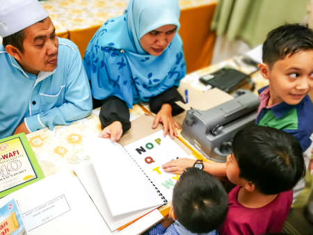 Bangi, Malaysia - May, 2018 : Colourful letters on the book as reference for the child to type into the braille typwriter.のeditorial素材