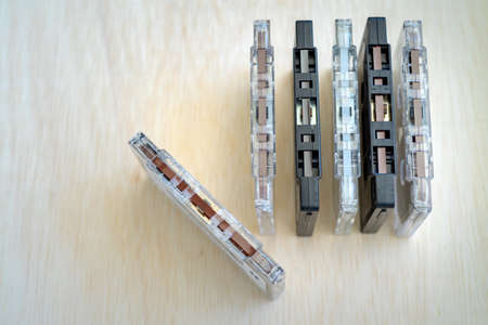 Set of old audio cassettes on wooden background