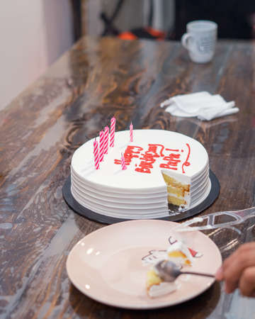 Birthday Cake for Dad written Happy Birthday Papa on the table. Candle on cake.