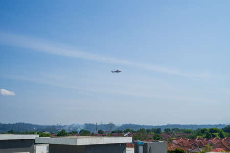 Bandar Seri Putra, Malaysia - June 3, 2021 Police helicopter maneuvers over the city during the Movement control order lockdown.のeditorial素材